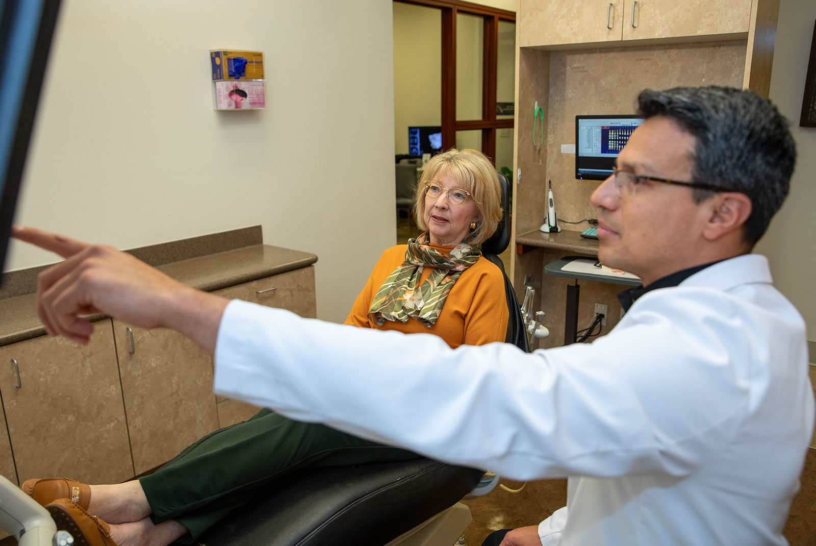 doctor and patient going over dental procedure information