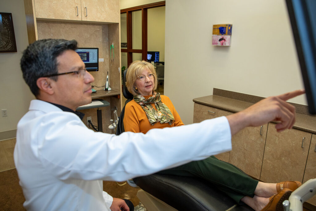 doctor and patient going over dental treatment information