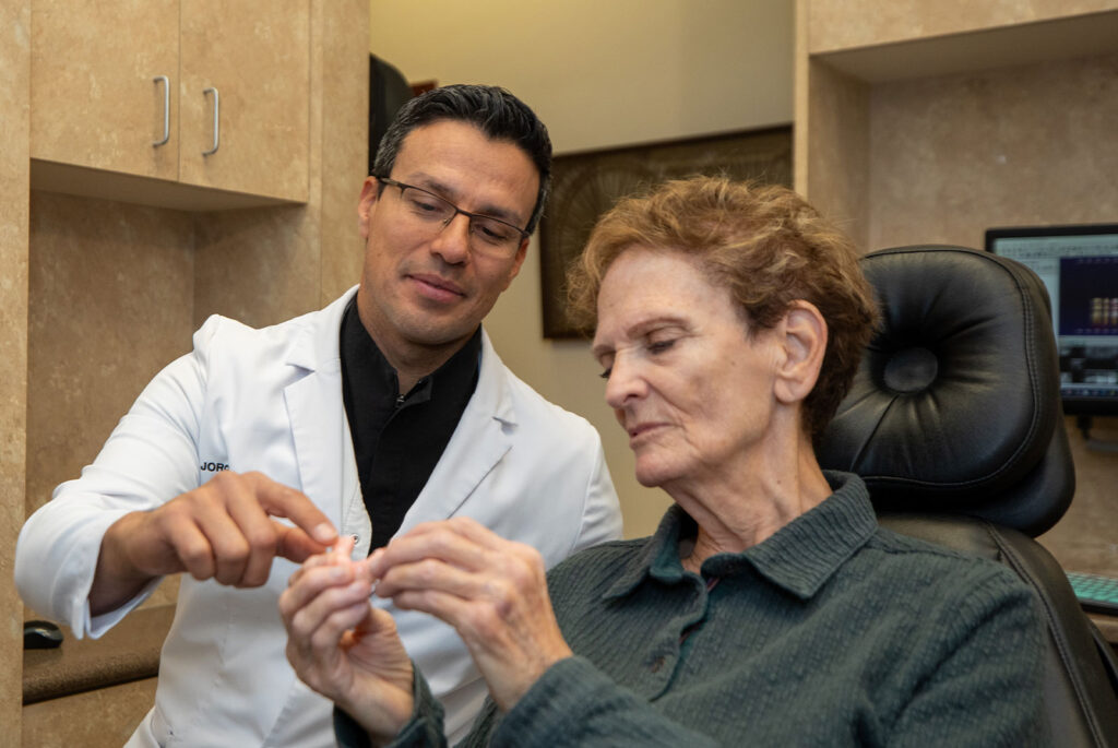 patient and doctor going over a full arch model before dental treatment