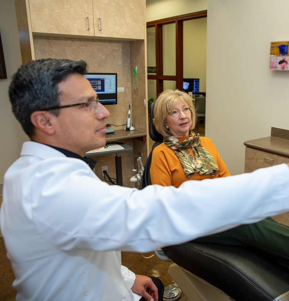 doctor and dental patient going over dental procedure information
