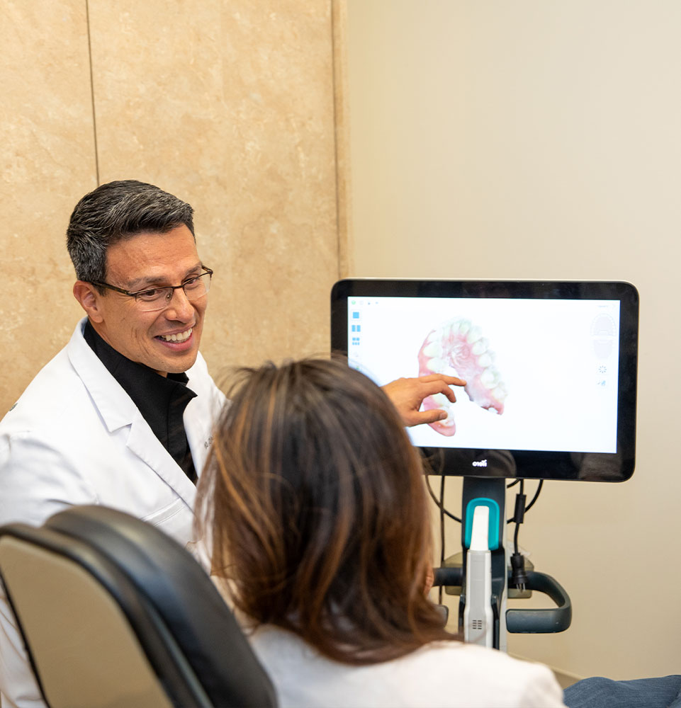 doctor going over dental procedure information with patient