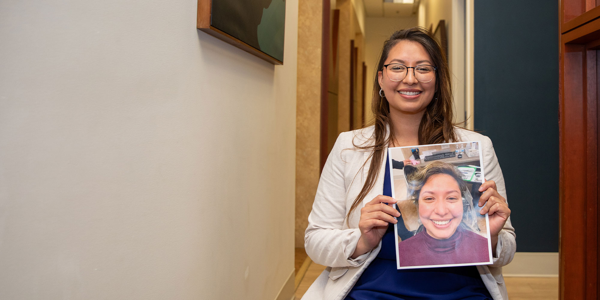 patient holding their before procedure image within the dental center
