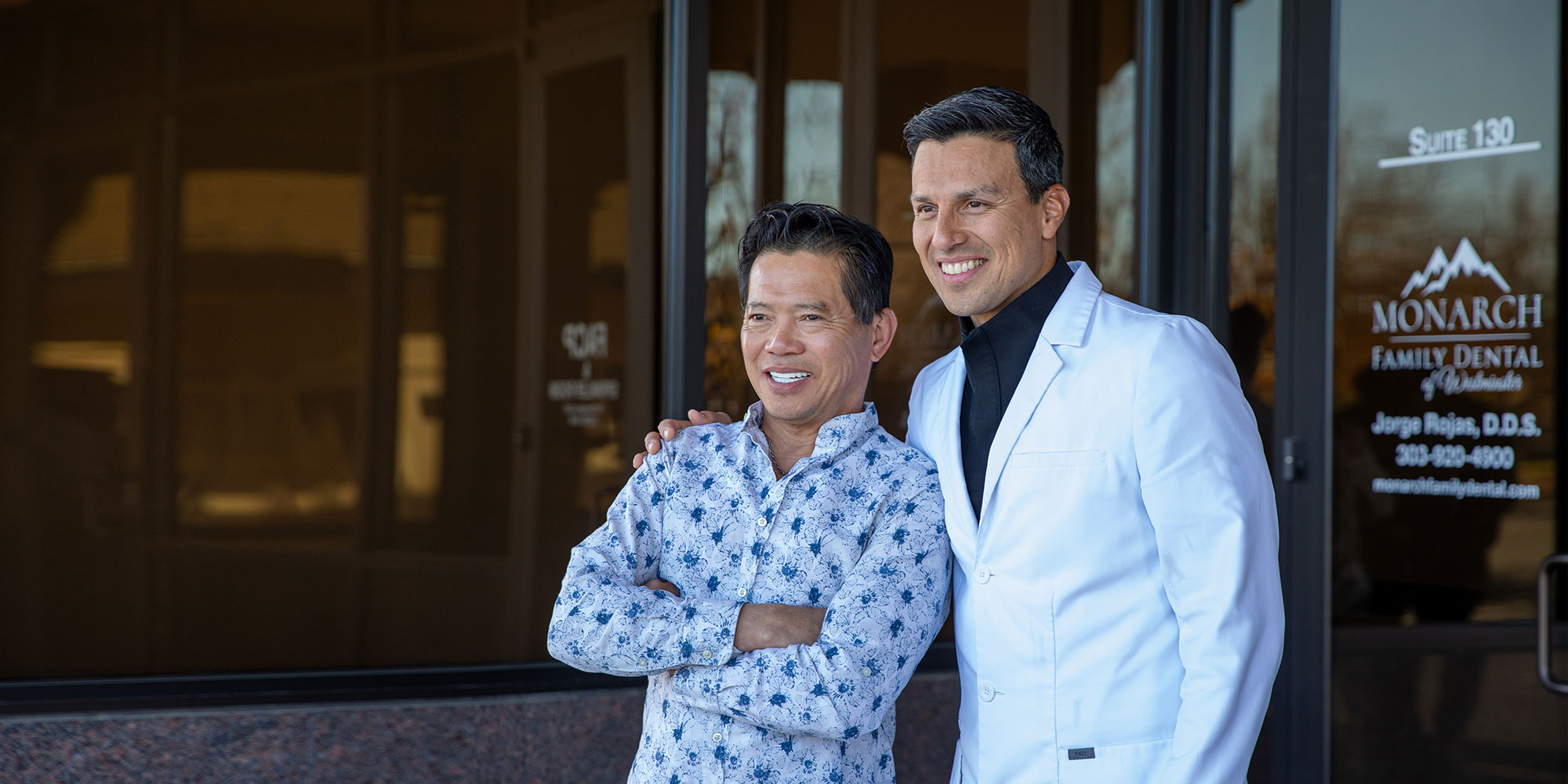 doctor and patient smiling brightly after dental treatment