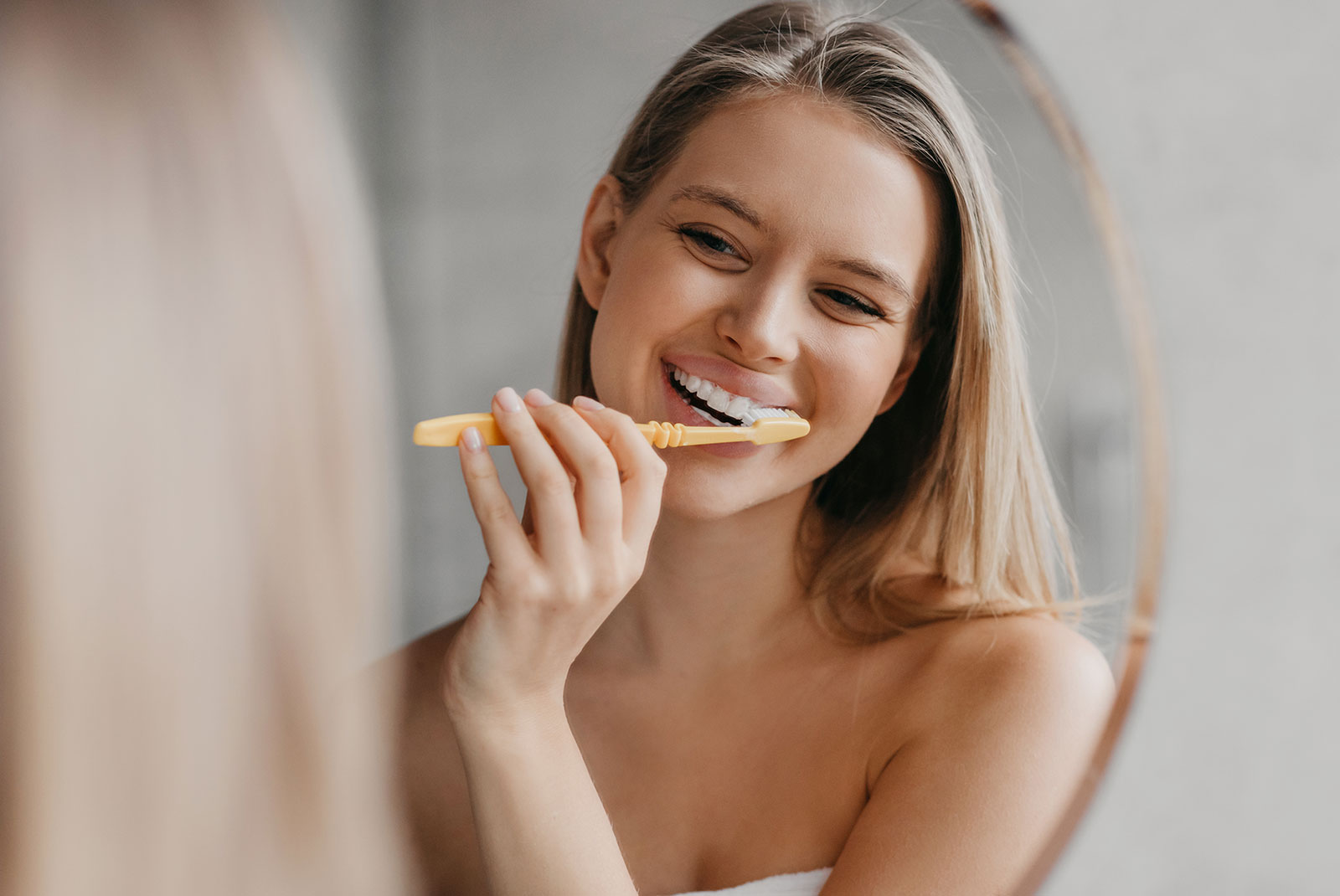 young beautiful women brushing her teeth