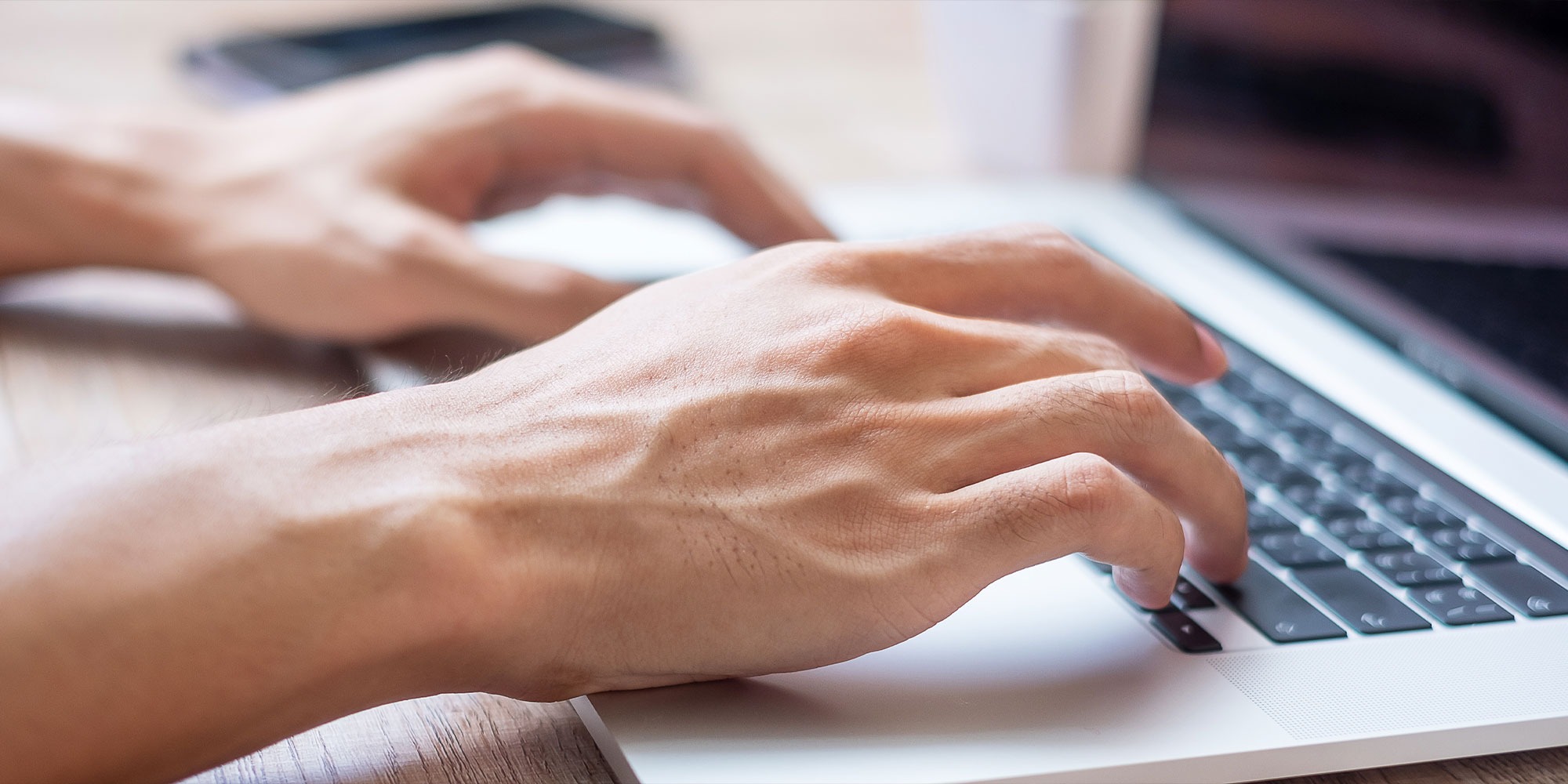 Guy hands typing on a laptop to publish the latest blog